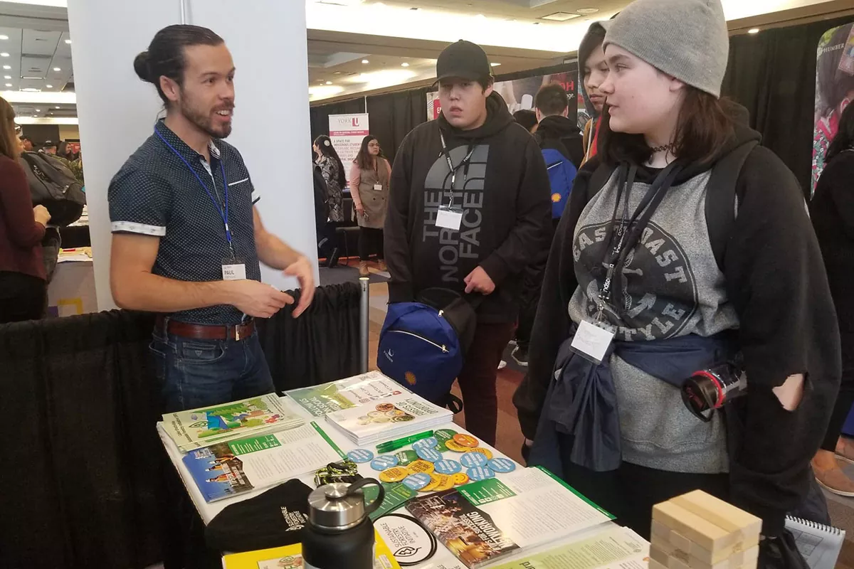 Paul speaks with a young Indigenous woman