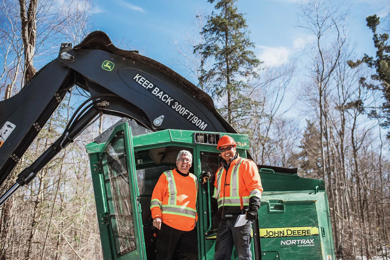 Dean and partner on John Deere Nortrax