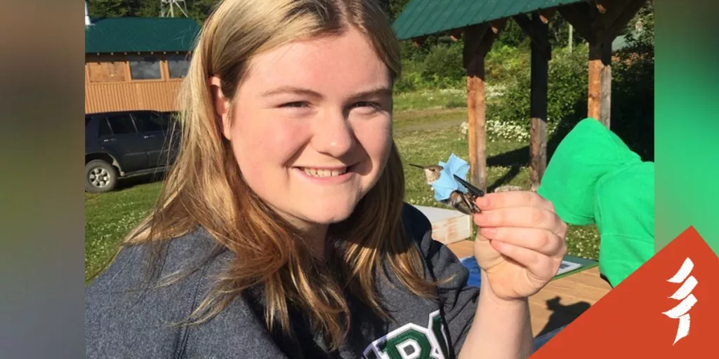 Nicole Boyde, an Education Assistant with the Chuntoh Education Society, banding a hummingbird, and helping teach ecological knowledge