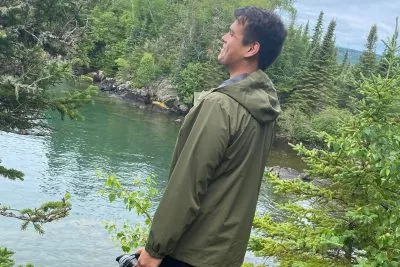 A young person looks over the water