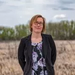 Bev Gingras standing in a field