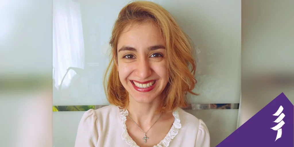 Headshot of Elina smiling at the camera, she says you should network