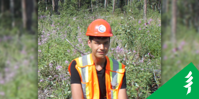 Photo of Gage in a hard hat and vest