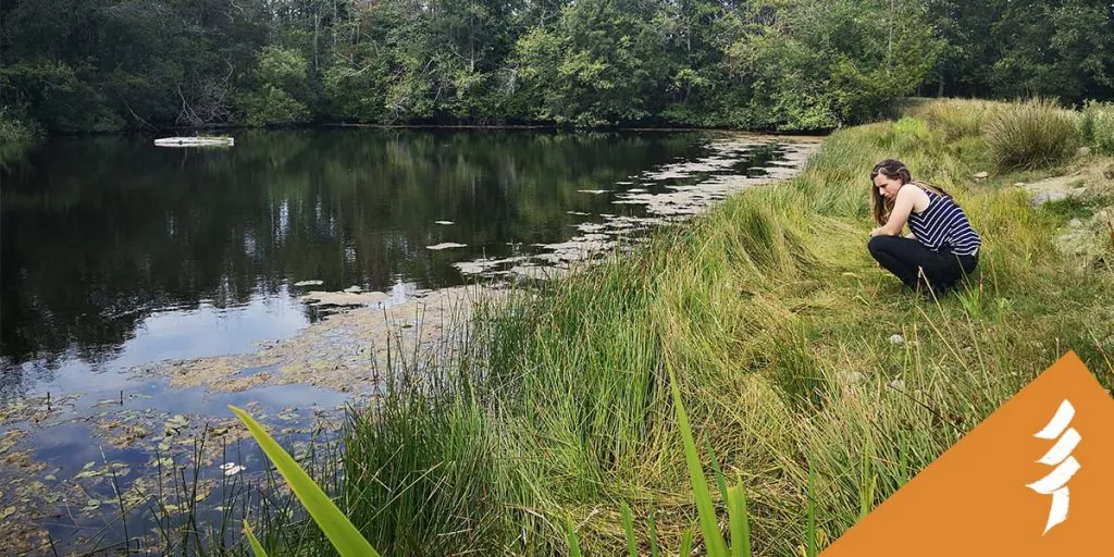 A young woman looking at a body of water