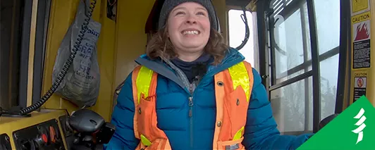 thumbnail of lacey driving a harvester