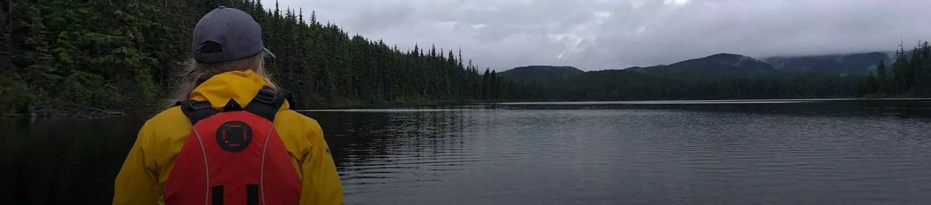 young woman looking out over a lake