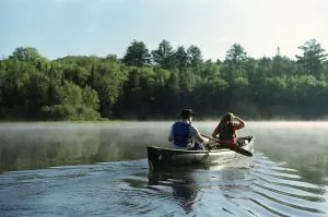 Two people canoeing on a lake