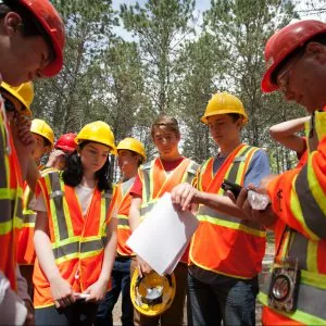 A group of people in high vis gear, arranged in a half circle
