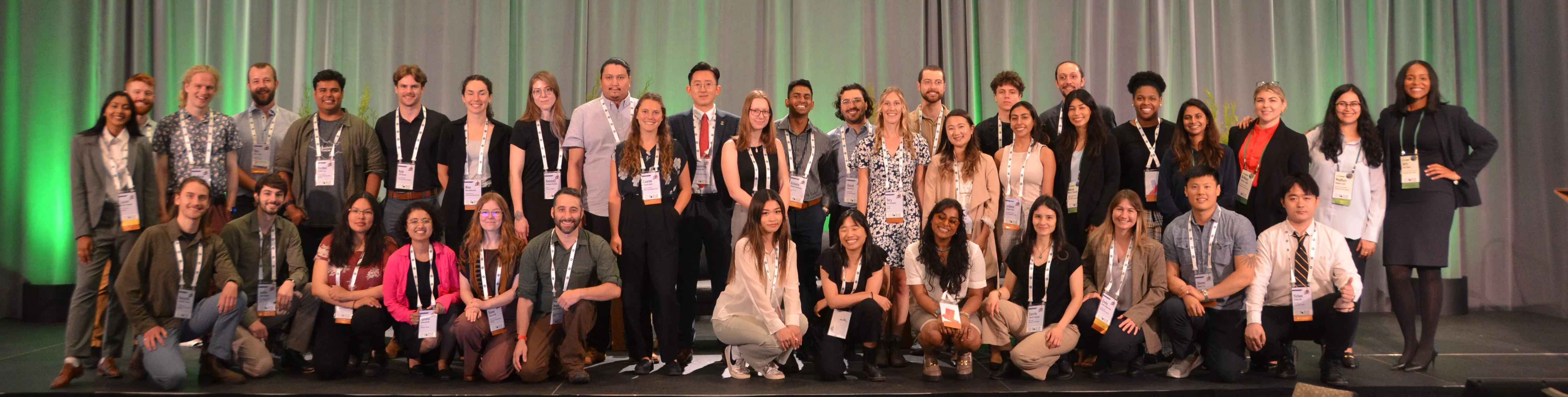 40+ youth delegates posing for a photo on stage at the 2023 SFI Annual Conference.