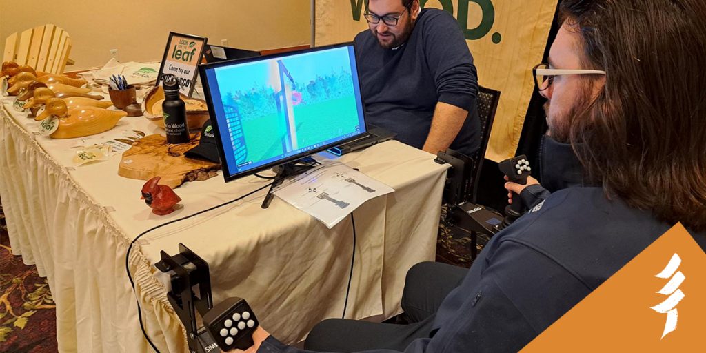A young man tests the heavy equipment simulator at the MNR booth.