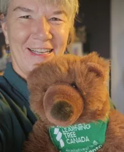 Suzanne Hale holding a teddy bear.