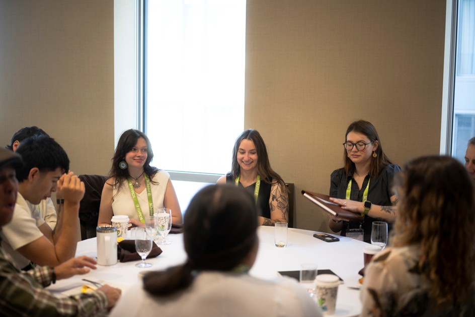 group of Indigenous youth delegates around a table