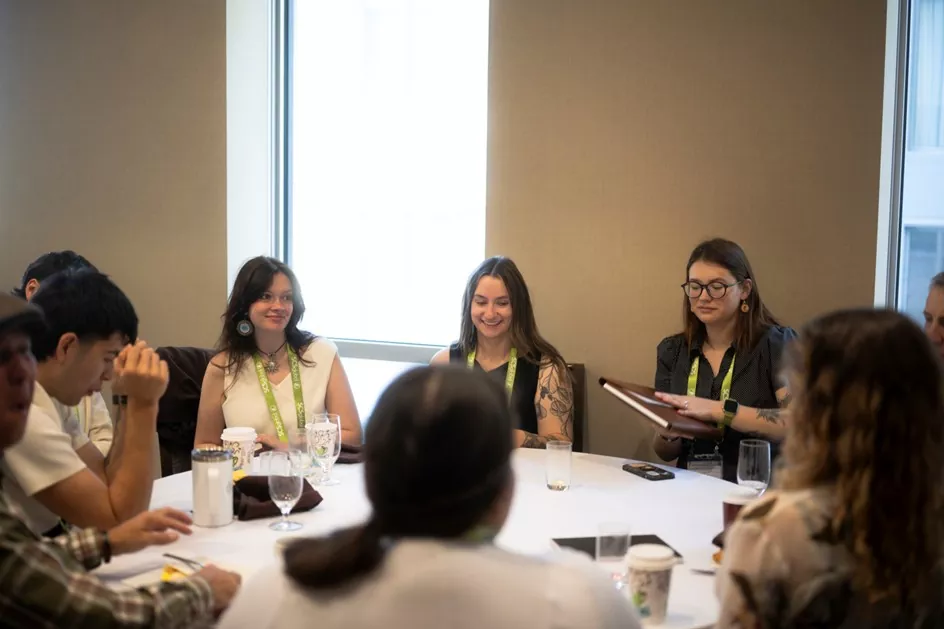 group of Indigenous youth delegates around a table